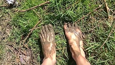 Hot sexy teen walking near the river, put feet in the mud